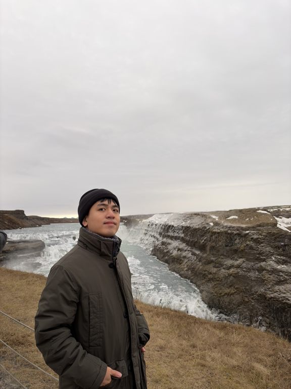 Tung Do standing by Gullfoss waterfall